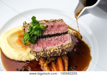 medium done grilled tuna steak in batter served with the baby carrot and mashpotato