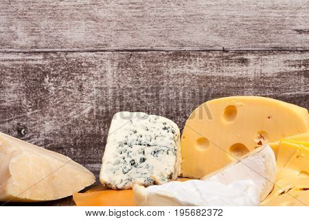 Different type of cheese on wooden background. Gourmet food apetizer