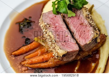medium done grilled tuna steak in batter served with the baby carrot and mashpotato
