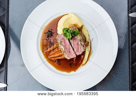 medium done grilled tuna steak in batter served with the baby carrot and mashpotato