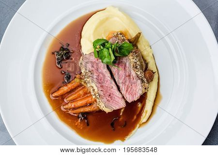 medium done grilled tuna steak in batter served with the baby carrot and mashpotato