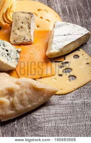 Different type of cheese on wooden background. Gourmet food apetizer
