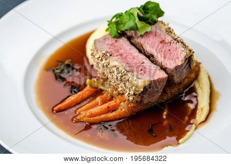 medium done grilled tuna steak in batter served with the baby carrot and mashpotato