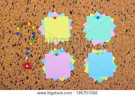 colorful sticky notes on cork bulletin board. Question mark made of pushpins