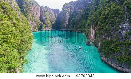 Aerial drone view of iconic tropical turquoise water Pileh Lagoon surrounded by limestone cliffs, Phi Phi islands, Thailand
