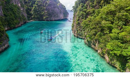 Aerial drone view of iconic tropical turquoise water Pileh Lagoon surrounded by limestone cliffs, Phi Phi islands, Thailand