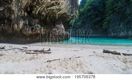Beach view of iconic tropical turquoise water Pileh Lagoon surrounded by limestone cliffs, Phi Phi islands, Thailand