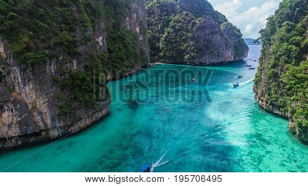 Aerial drone view of iconic tropical turquoise water Pileh Lagoon surrounded by limestone cliffs, Phi Phi islands, Thailand