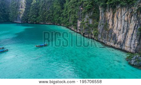 Aerial drone view of iconic tropical turquoise water Pileh Lagoon surrounded by limestone cliffs, Phi Phi islands, Thailand