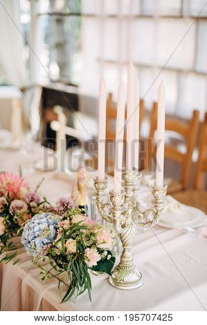 Candles on table with decor and flowers