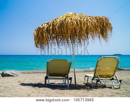  Crete Greece Agia Fothia Nomos Lassithi two beds with straw umbrella on the beach