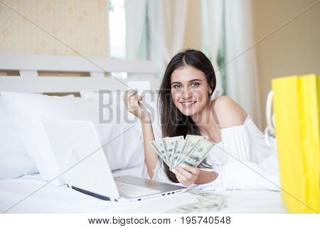 Young Woman Holding Money In Bed This Picture Focus On Money.