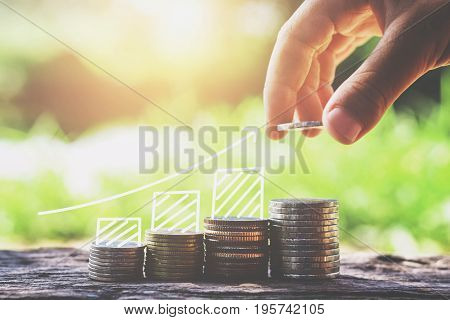 money saving concept hand puting coins stack growing business finance