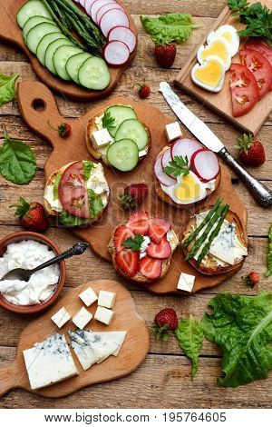 Set Of Healthy Whole Wheat Bread Sandwiches With Fuits, Vegetables, Cheese And Leafy Green Herbs On