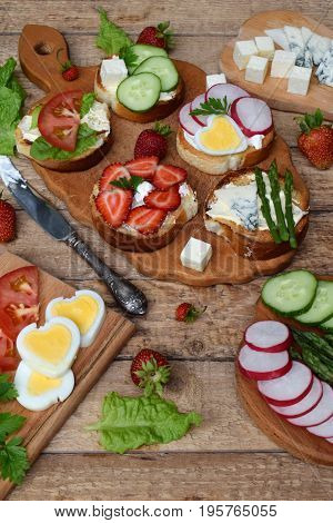 Set Of Healthy Whole Wheat Bread Sandwiches With Fuits, Vegetables, Cheese And Leafy Green Herbs On