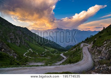 Dirt Mountain Road Leading To High Mountain Pass In Italy (colle Delle Finestre). Expasive View At S