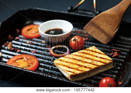 ofu on the grill on the table on a black background, view from the top