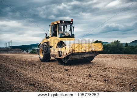 Vibratory Soil Compactor Working On Highway Construction Site
