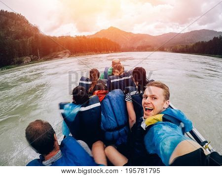 tourist man sitting in a boat and happy, a boat with a motor rides at high speed along the river. Concept rafting