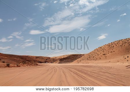 The wide view of desert with cars and blue sky