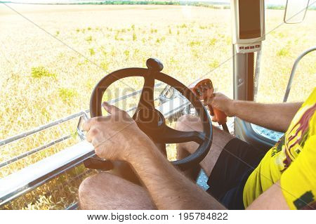 View from the cab of a combine harvester and the farm manager of the combine harvester
