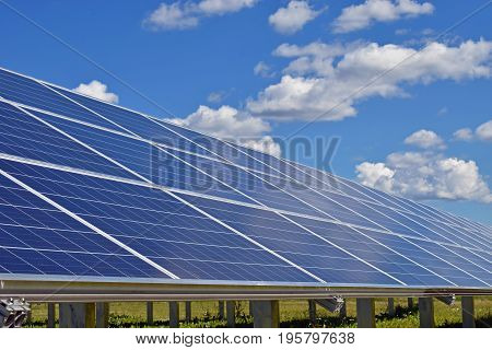 Close up of solar panels. Beautiful cloudy sky on background.