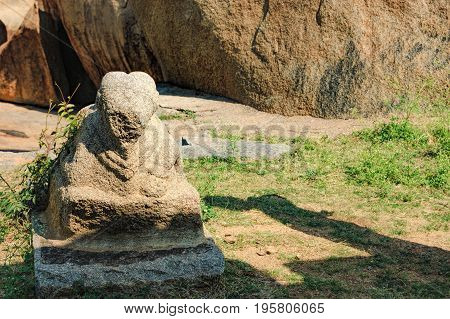 An ancient statue of a lion in the ruins of ancient city Vijayanagar on Hemakuta hill in Hampi, Karnataka, India.