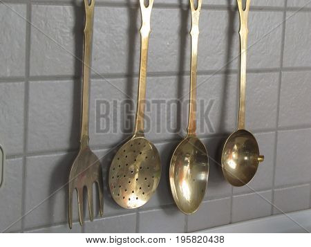 Large brass spoons kitchen hanging on the wall