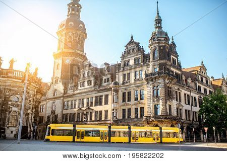 View on the old castle with Hausmannsturm tower and yellow tram in Dresden city during the sunrise in Germany