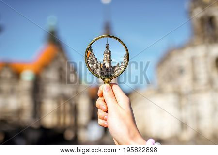 Watching though a magnifying glass on the Hausmannsturm tower of the old castle in Dresden, Germany