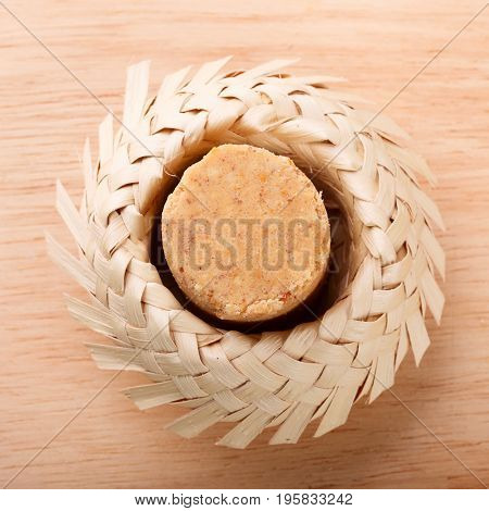 Pacoca - brazilian candy of ground peanut in wicker hat of Festa Junina. Selective focus. Copy space