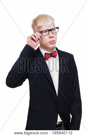 Albino young man portrait. Blond guy in suit with red bow tie isolated at white background. Albinism, pale skin. Stylish young boy in eye glasses and suit.