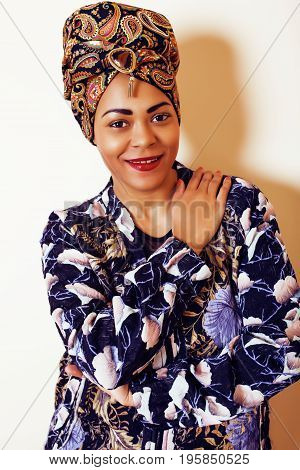beauty bright african woman with creative make up, shawl on head like cubian closeup smiling, cheerful tan , lifestyle people concept close up
