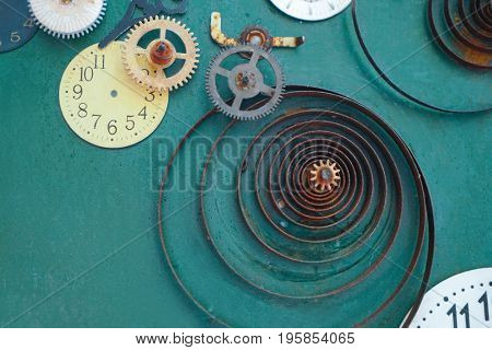 Creative composition with parts of mechanical clock on grunge background