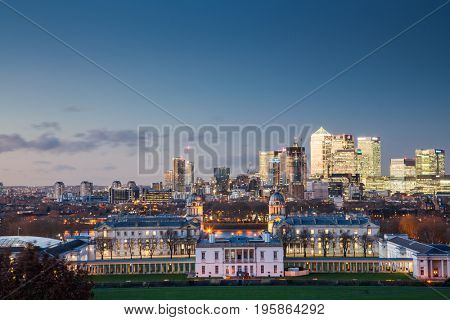 London, UK - JANUARY 7, 2016: Panoramic view from Greenwich on Canary Wharf financial district with skyscrapers at night. View includes the park, National Maritime Museum, Royal chapel and O2.