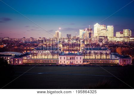 London, UK - JANUARY 7, 2016: Panoramic view from Greenwich on Canary Wharf financial district with skyscrapers at night. View includes the park, National Maritime Museum, Royal chapel and O2.