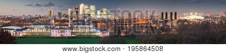 London, UK - JANUARY 7, 2016: Panoramic view from Greenwich on Canary Wharf financial district with skyscrapers at night. View includes the park, National Maritime Museum, Royal chapel and O2.