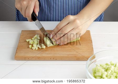 Step By Step Recipe For Tarator. Hands Cut A Cucumber On Board In The Kitchen.