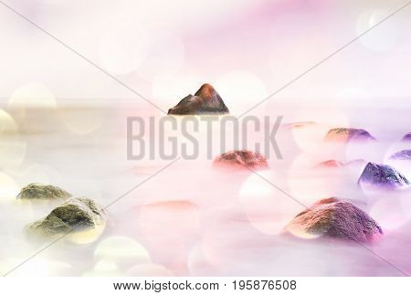 Film Effect. Romantic Morning At Sea. Big Boulders Sticking Out From Smooth Wavy Sea. Pink Horozon W