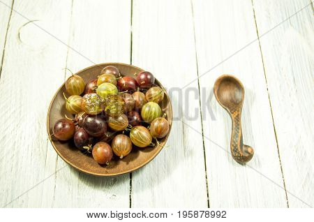 Sliced Berry Gooseberries. Multicolored Berries Of Gooseberries On A Plate. Clay Dishes.
