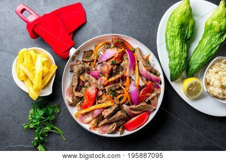 Peruvian Dish Lomo Saltado - Beef Tenderloin With Purple Onion, Yellow Chili, Tomatoes In Pan. Tot V