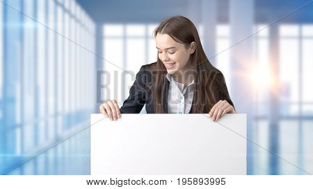 Young Beautiful Business Woman And Creative Designer Standing Over Blured Interior Background