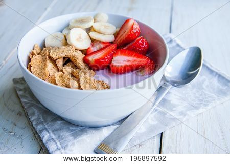 Healthy Breakfast which included cornflakes and oatflakes, yogurt, bananas and strawberries
