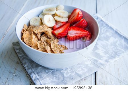Healthy Breakfast which included cornflakes and oatflakes, yogurt, bananas and strawberries