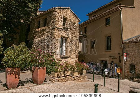 Lourmarin, France - July 07, 2016. View of quiet alley with stone buildings and shops in the lovely village of Lourmarin. Located in the Vaucluse department, Provence region, southeastern France