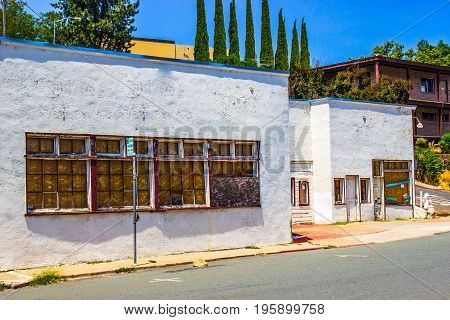Store Front Buildings With Boarded Up Windows & In Need Of Repair