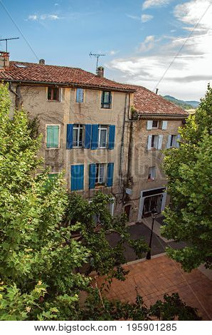 View of houses on a square in the historical center of the village Rians, at the end of the day. Located in the Var department, Provence-Alpes-Côte d'Azur region, southeastern France