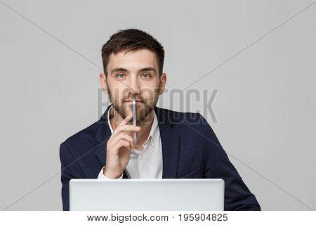 Business Concept - Portrait handsome happy handsome business man in suit playing moblie phone and smiling with laptop at work office. White Background.