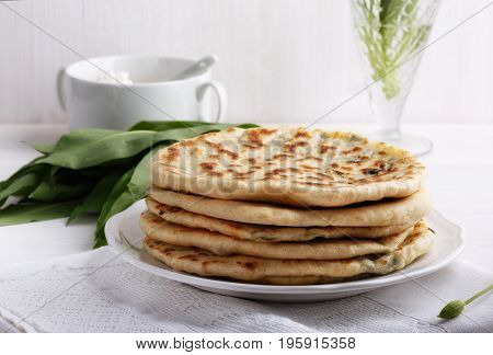 Khychiny - traditional caucasian flatbread filled with сheese and herbs. Flat bread stuffed with feta and wild garlic.