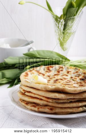 Khychiny - traditional caucasian flatbread filled with сheese and herbs. Flat bread stuffed with feta and wild garlic.